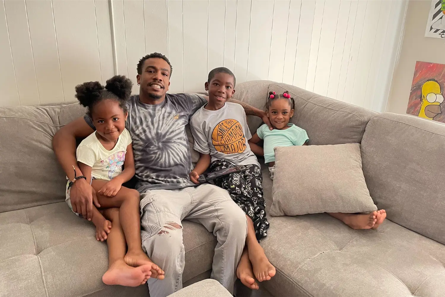 Father and children sitting on couch