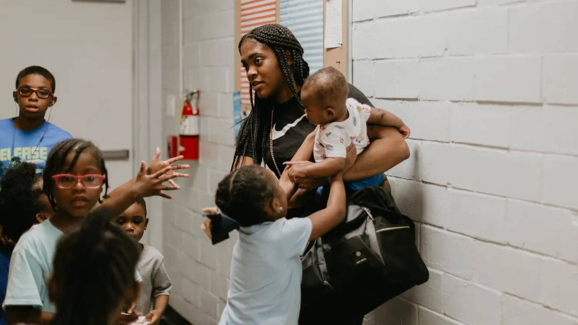 Woman holding baby in the hallway