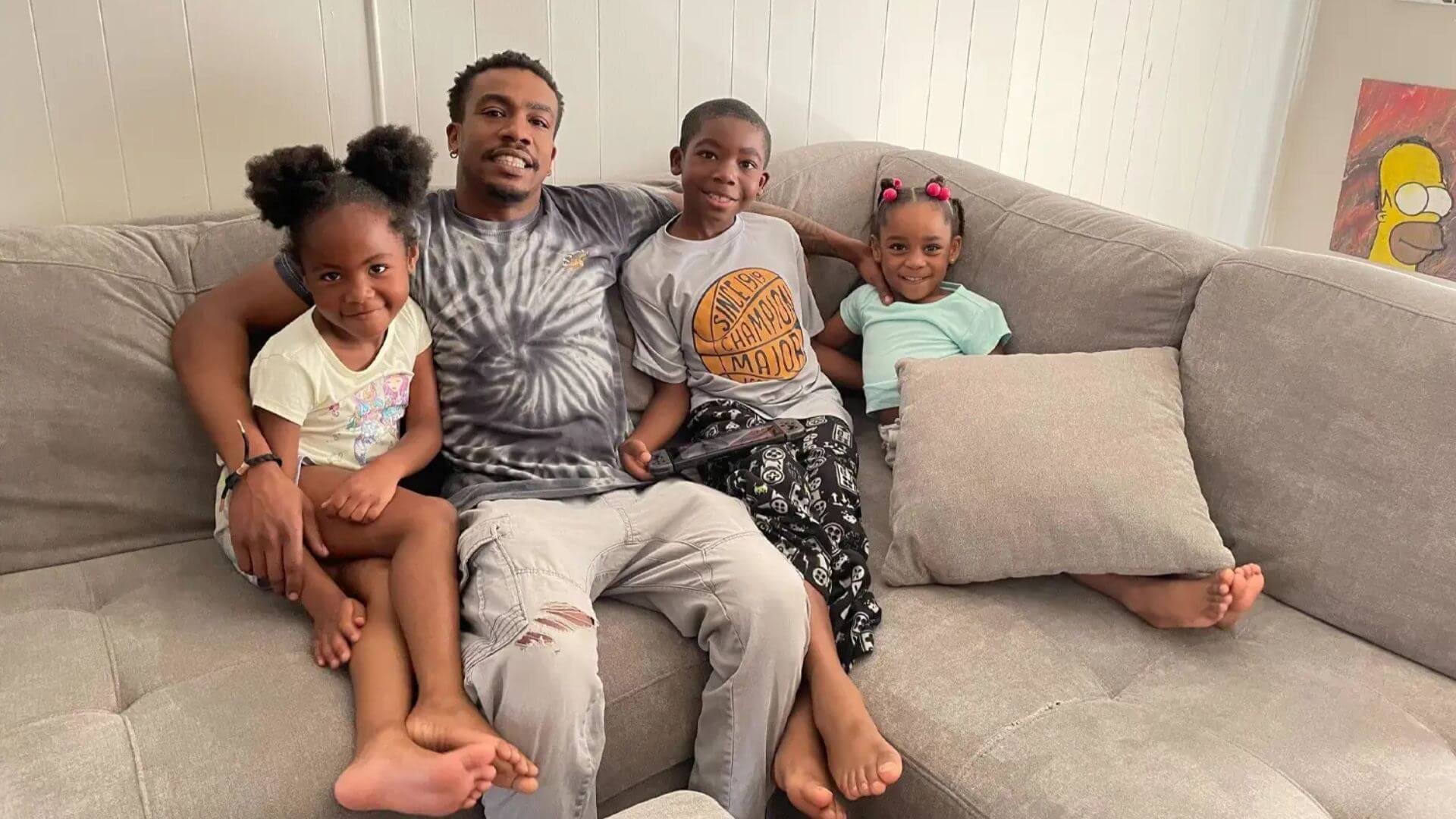 Man sitting on the couch with his kids